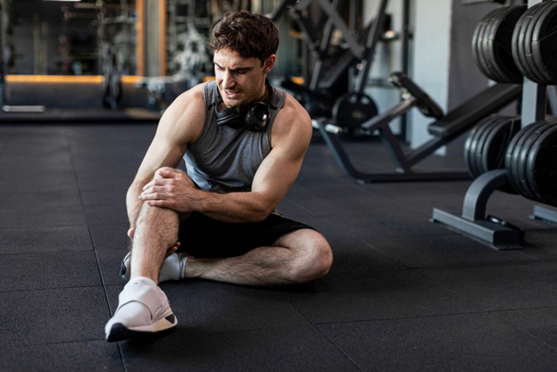 A person sitting on the floor in a gym
AI-generated content may be incorrect.